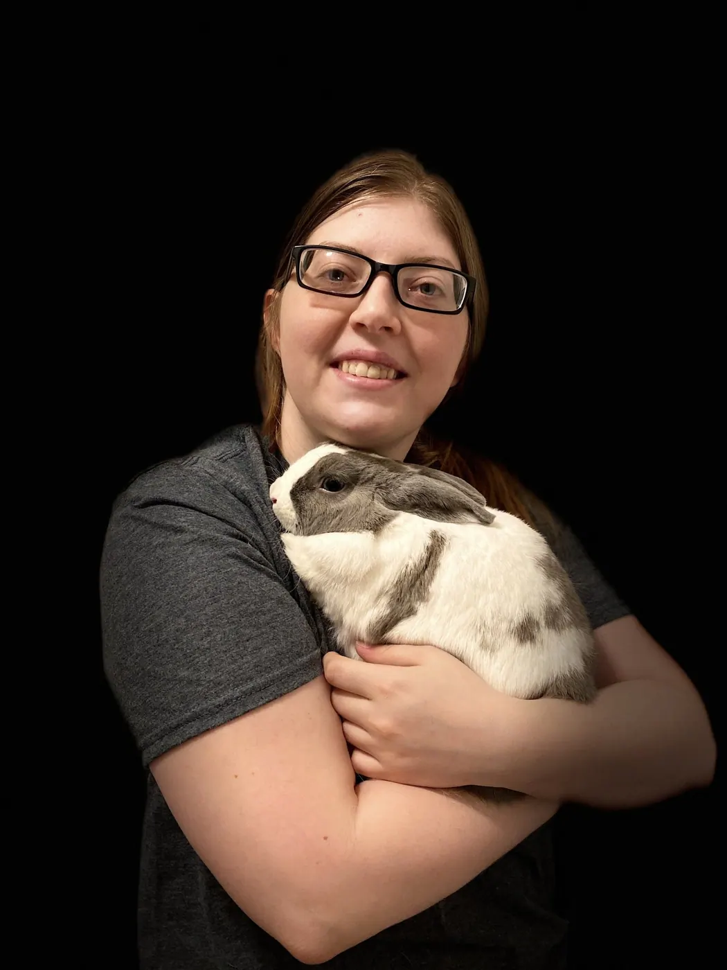 Devyn, a Hooman on Demand pet sitter, holding a rabbit